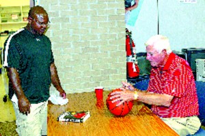 Orrville Basketball Coach Sly Slaughter gets a basketball signed by coach Bobby Knight at 'A Night with Knight' Sunday evening. "It’s great that the community gets to hear stories from Bobby Knight, we appreciate all he does for the high school and community," Slaughter said of the event.